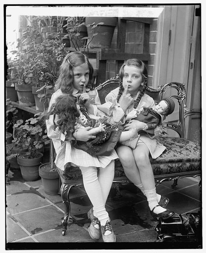 Two young girls with dolls