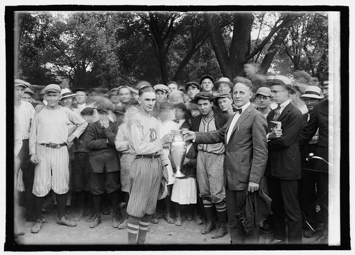 Member of sports team receiving trophy