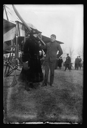 Woman and man next to airplane