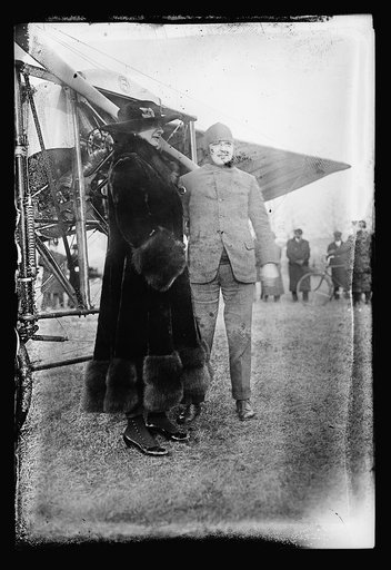 Woman and man next to airplane
