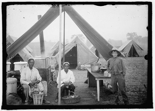 U.S. Army cook tent, peeling potatoes