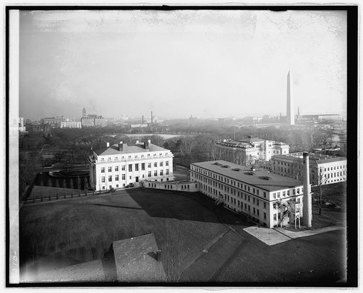 Aerial view over south lawn of looking southeast toward Washington Monument, with American Red Cross building and Memorial Continental Hall (DAR) in foreground. Washington D.C.