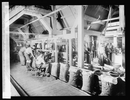 Weighing, filling and sewing 100 lb. sacks of sugar