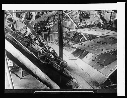 Separators one of which is open, showing three screens for separating the sugar grains