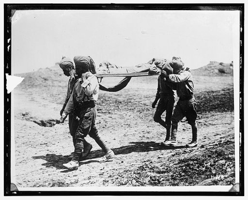 Man being carried on stretcher