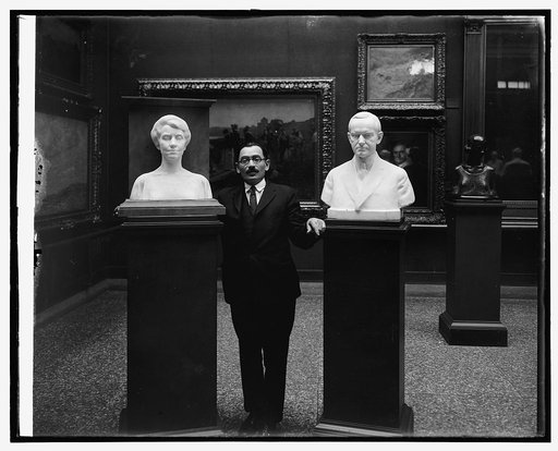 M.W. Dykaar with busts of Pres & Mrs. Coolidge at National Gallery, [Washington, D.C.