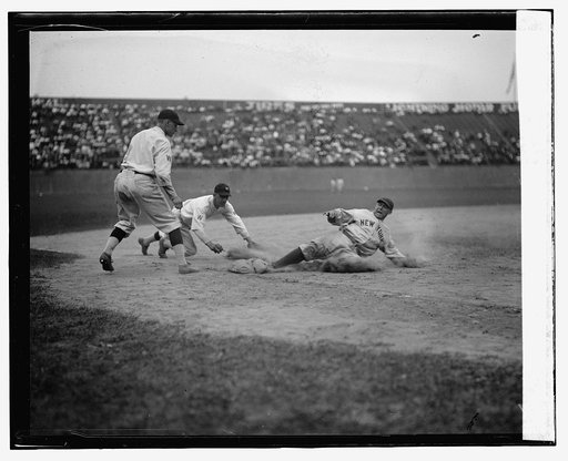 Yankees catcher Wally Schang slides safely into 3rd base in second game. Senators 3rd baseman is Ossie Bluege and pitcher backing up play is Firpo Marberry. Senators won 2nd game 7-2 (baseball)