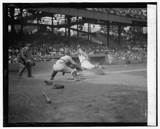 Senators Goose Goslin slides safely into home and collides with Yankees catcher Wally Schang in 2nd game of double header (baseball)