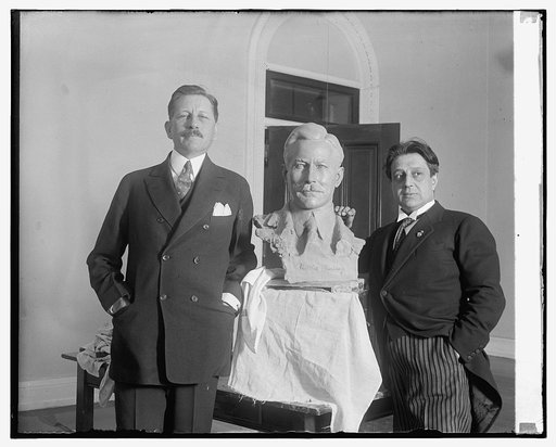 War Secretary poses for bust by noted sculptor. Secretary of War Patrick J. Hurley posing for the final touch of a bust of himself which is nearing completion at the hands of Edgardo Simone, noted Italian sculptor, who has been modeling a number of prominent personages at his stucio in Washington
