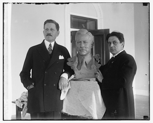 War Secretary poses for bust by noted sculptor. Secretary of War Patrick J. Hurley posing for the final touch of a bust of himself which is nearing completion at the hands of Edgardo Simone, noted Italian sculptor, who has been modeling a number of prominent personages at his studio in Washington