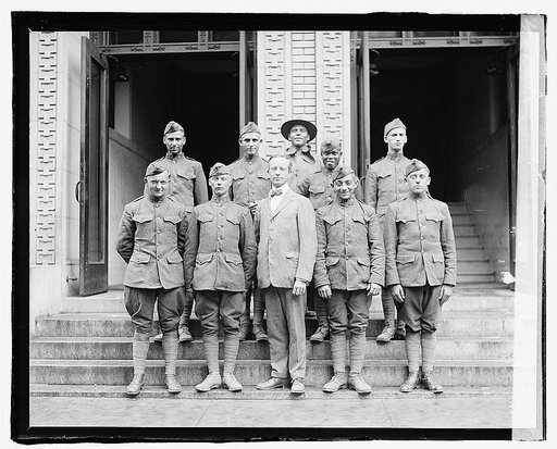 Small group of overseas soldiers who applied for Naturalization, June 6, 1919. Man in center is Raymond Christ, Director of Citizenship, Bureau of Naturalization, Department of Labor