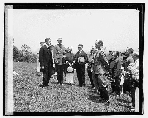 Secty. Baker & Genrl. March decorating grave of French soldier Bastille Day