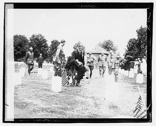 Secty. Baker decorating graves of French Soldiers Bastille Day