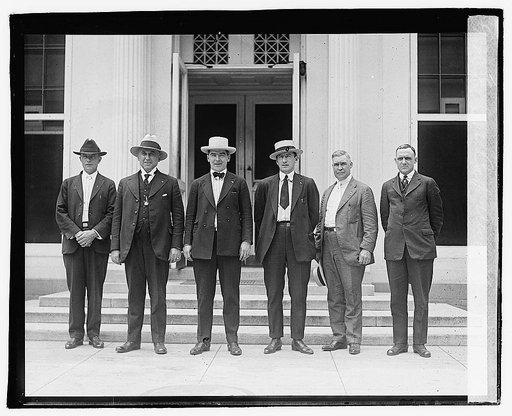 Six men standing in a row at one of the Capitol doors(?), Aug. 5, 1920