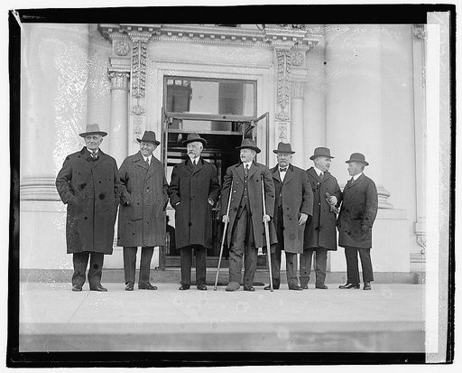 Seven men standing outside building], 12/6/20
