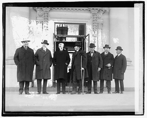 Seven men standing outside building], 12/6/20