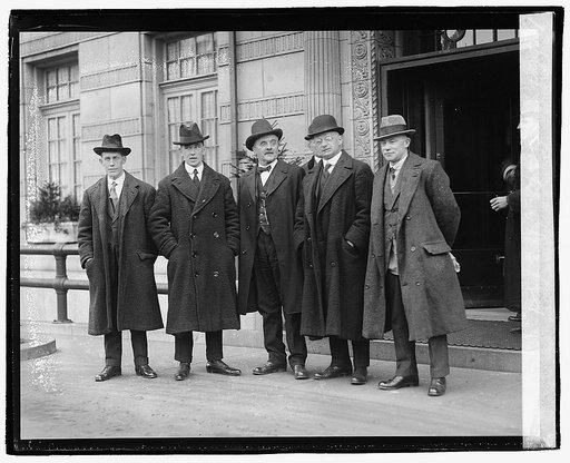 Five unidentified men standing in front of building], 1/13/21