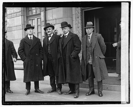 Unidentified men standing in front of building], 1/13/21