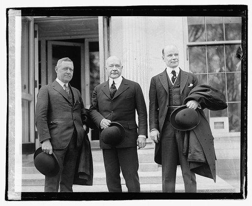 Three men standing on steps outside building], 3/29/21