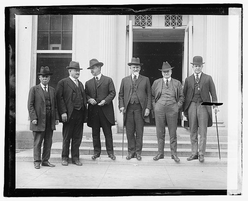 Group of six unidentified men standing on steps of building] 4/23/21