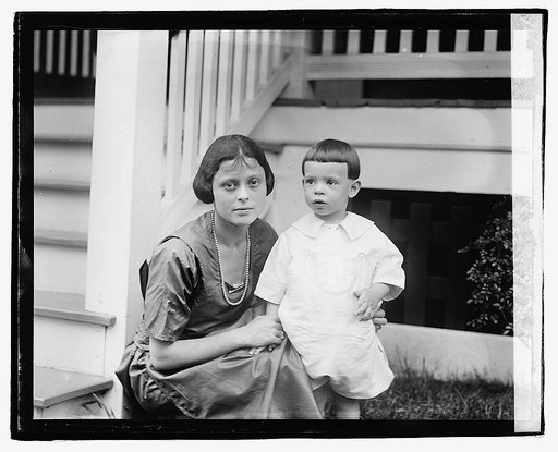 Unidentified woman and child in front of porch