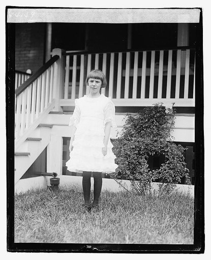 Unidentified child standing in front of porch