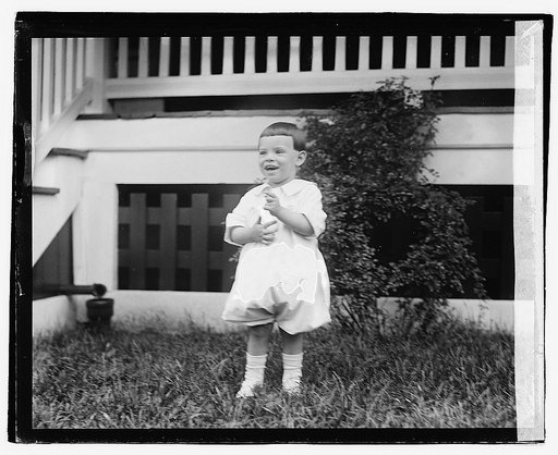 Unidentified child in front of porch