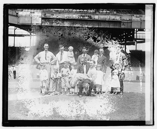 Group portrait of men and children in stadium