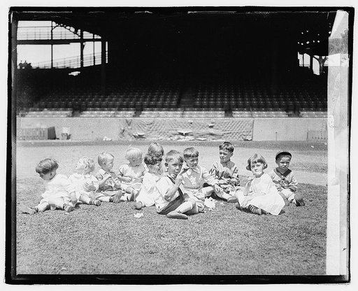 Group portrait of children in stadium