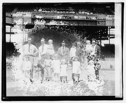 Group portrait of men and children in stadium