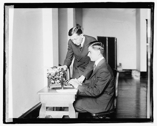 Unidentified men using typing machine