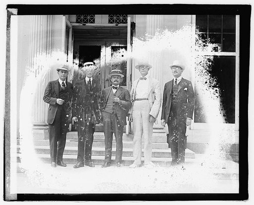Unidentified men standing on steps of office building