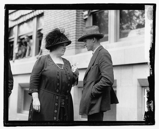 Unidentified woman and man outside city building