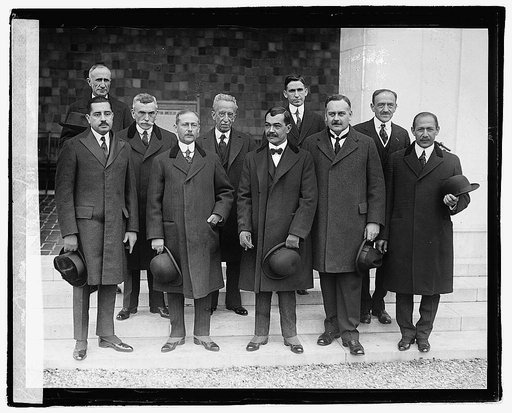 Group of unidentified men standing on steps of building], 11/23/21