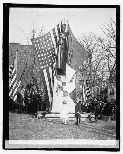 Two children in front of statue of Dante, crowd of people and flags], 12/1/21