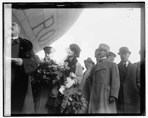 People standing under dirigible