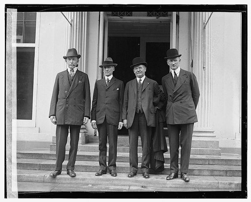 Four unidentified men standing outside building], 5/18/22