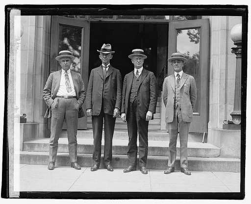 Four unidentified men outside building], 5/31/22