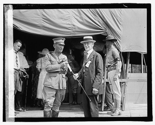 Two men outside tent building