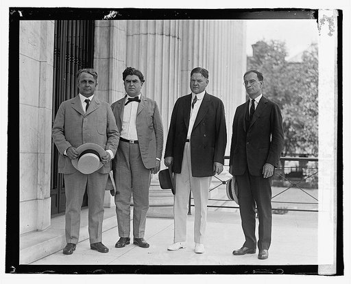 Four men standing outside building], 7/2/22