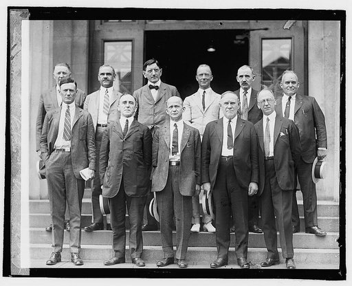 Group of unidentified men standing on steps outside building], 8/5/22