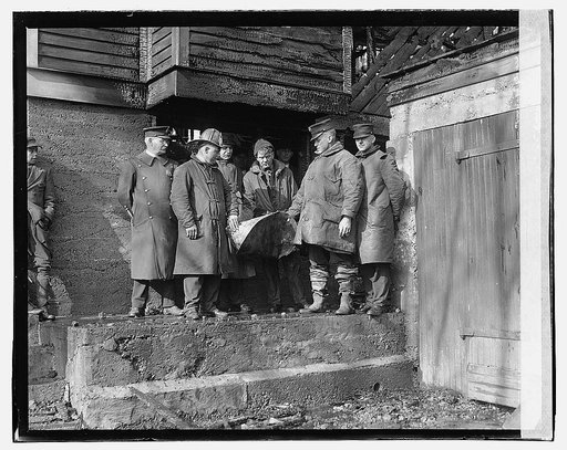 Firefighters outside house ruins