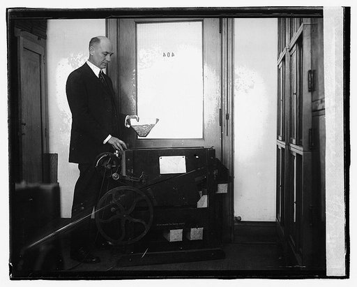E. G. Boerner in charge of grain cleaning investigations of the Dept. of Agrl. The Dept. has perfected a method of separating foreign materials from wheat which is saving farmers millions of bushels yearly, suitable for feed for livestock. 3/9/23