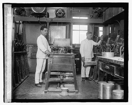 B. F. Nally and J. F. Hayes, expert millers, opening a flour mill in the Dept. of Agrl. to determine the milling values of various varieties and grades of wheat grown in the U.S. 3/9/23
