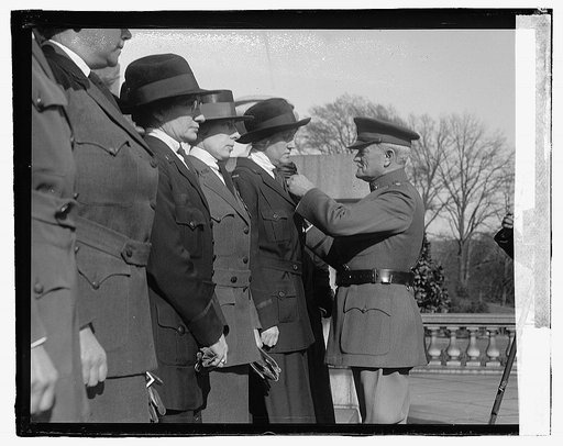Unidentified uniformed women and man, ceremony on steps