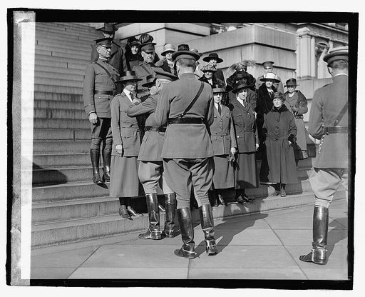 Unidentified uniformed women and man, ceremony on steps