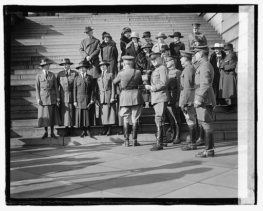 Unidentified uniformed women and man, ceremony on steps