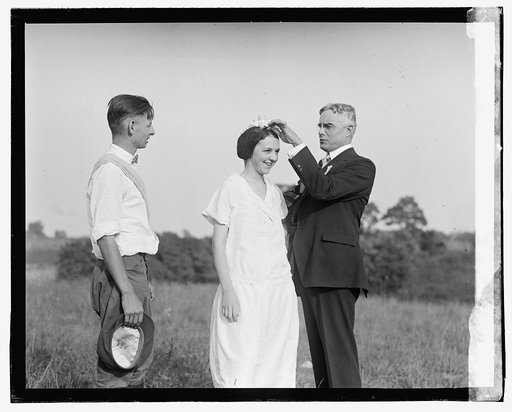 Unidentified men and woman in field