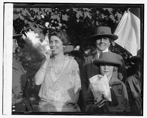 Mrs. Coolidge eating cookies [with Girl Scouts], 10/17/23