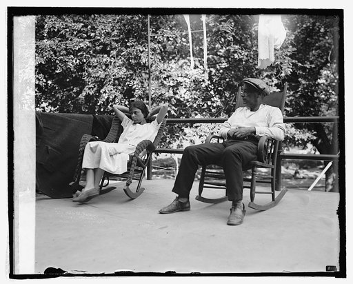 Woman and man seated in rocking chairs